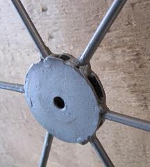 Close up of large washer with rods welded
